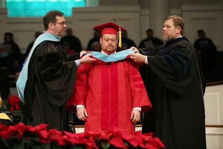 Ken Litscher, doctor of education graduate, receives his hood during the fall commencement services.  - Photo by Kristi McMurry Woody