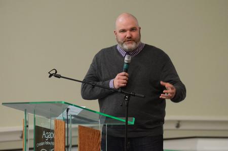 Russ Pflasterer, pastor at City Fellowship Baptist Church, lead the closing prayer at the Diversity and Reconciliation Dialogue at Agape Christian Fellowship.  - Photo by Elizabeth Wilson