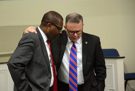 Moses Goldman, executive vice president at Lane College, and Todd Brady, vice president for university ministries at Union University, support each other in prayer before leaving the Diversity and Reconciliation Dialogue at Agape Christian Fellowship.  - Photo by Elizabeth Wilson