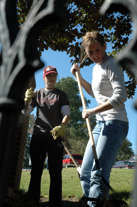 Nursing majors Shana Willows & Mimi Suber rake leaves at Birth Choice during Day of Remembrance. - Photo by Amanda Herron