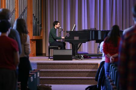 Cody Curtis, assistant residence director, helps lead music during chapel. - Photo by Kristi McMurry Woody