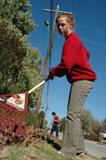 Junior Melody Pickerill rakes leaves at Birth Choice during Day of Remembrance. - Photo by Amanda Herron
