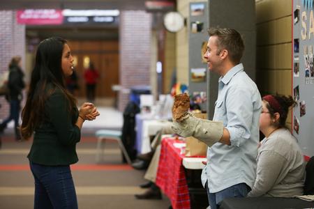 James Kerfoot, associate professor of biology, works a table at the Study Abroad Fair.  - Photo by Kristi McMurry Woody