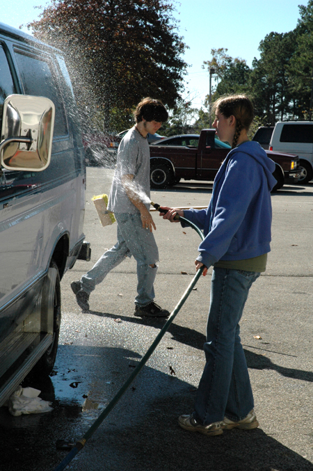 Tyson Cadenhead & Heather Couch wash a van at Birth Choice during Day of Remembrance. - Photo by Amanda Herron
