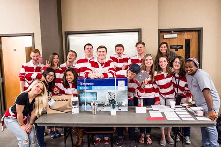 The Student Activities Council poses around the various prizes for Bingo Night in the Brewer Dining Hall. - Photo by David Parks