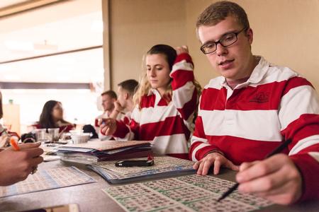Student Activities Council members Olivia Johnston, freshman nursing major, and Graham Gardner, junior mathematics major, take a break from handing out cards to participate in Bingo Night. - Photo by David Parks