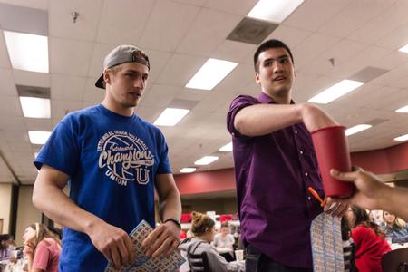Sophomore Jay Pope and Zakary Johnson, senior mathematics major, anxiously draw after a tie to determine who will win a prize during SAC's Bingo Night. - Photo by David Parks
