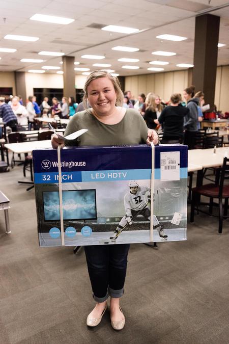 Bingo Night grand prize winner Sallie Norman, freshman music education major, poses for a photo with her new flatscreen television. - Photo by David Parks