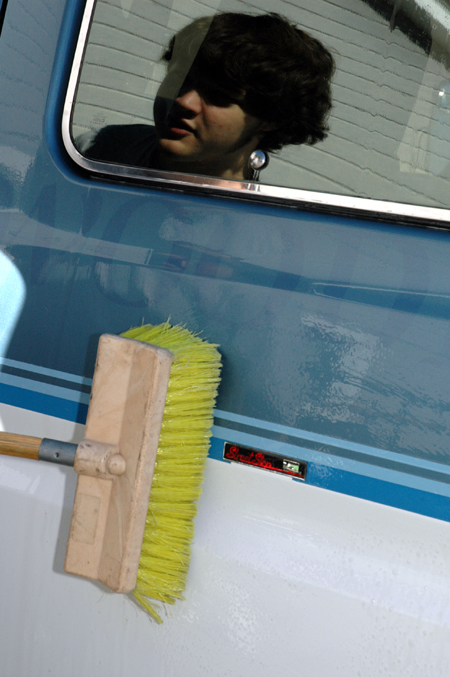 Sophomore Tyson Cadenhead washes a van at Birth Choice during Day of Remembrance. - Photo by Amanda Herron