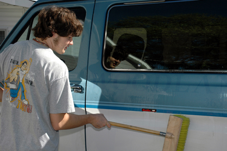 Sophomore digital media studies major Tyson Cadenhead washes a van at Birth Choice during Day of Remembrance. - Photo by Amanda Herron