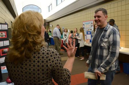 A student talks with a rep from a local organization during Social Work Awareness Day. - Photo by MiKalla Cotton