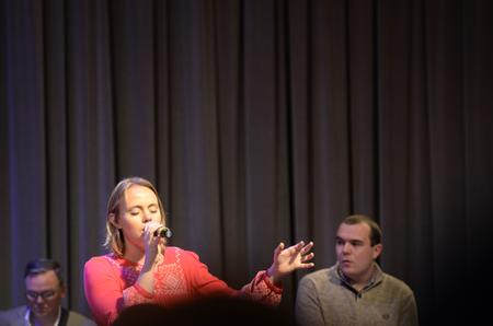 Corinne Olund, freshman business administration major, sings with the band as Travis Cotrell, worship leader at Englewood Baptist Church, leads a worship chapel service in the G.M. Savage Memorial Chapel. - Photo by MiKalla Cotton