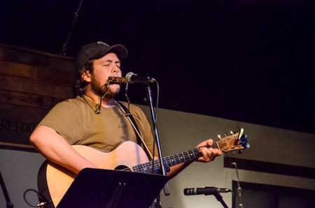Cameron Skonhovd, junior psychology major, performs at Barefoots Joe's Open Mic.  - Photo by Gretchen Foels