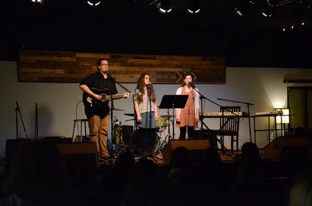Reed McLean, senior computer science major, Paula Nestico, junior music major, and Gina Nestico, public relations major, perform at Barefoots Joe's Open Mic.  - Photo by Gretchen Foels