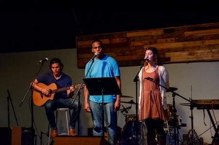 Tanner Cherry, sophomore computer science major, Tre Tharpe, junior social work major, and Gina Nestico, junior public relations major, perform at Open Mic.  - Photo by Gretchen Foels