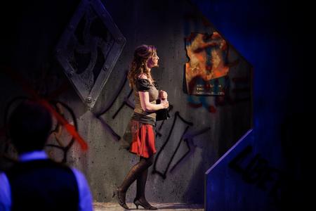Elizabel Riggs, playing Argia, walks off the stage at the end of The Queen and the Rebels, performed in the W.D. Powell Theatre and directed by David Burke. - Photo by Kristi McMurry Woody