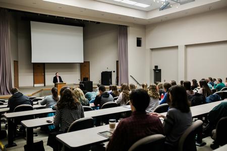 George David Clark, alum and poet, welcomes guests to his poetry reading during the Creative Writing Workshop.  - Photo by Kristi McMurry Woody