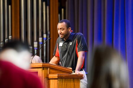 Jonathan Boyd, undergraduate admissions transfer coordinator, prays for the Boston Go Trip at chapel.  - Photo by Gretchen Foels