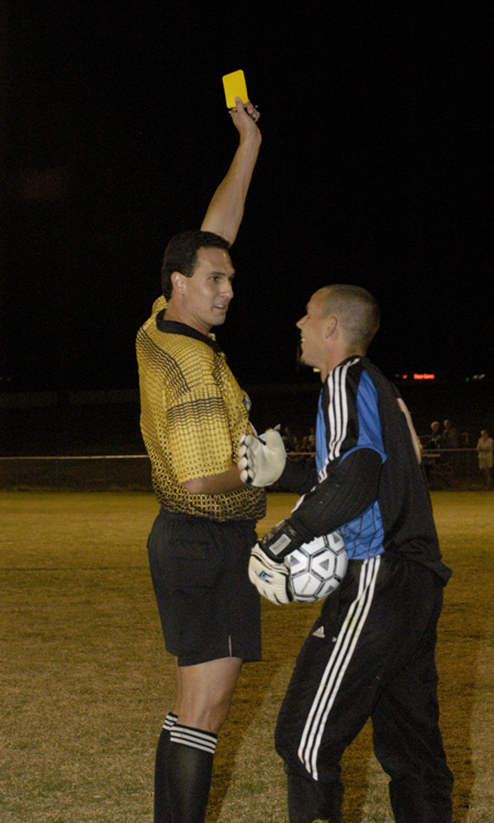 Junior goalie Robert Stinson laughs about getting a yellow card during a collision. - Photo by Kathleen Murray