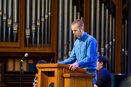Joshua Edgren, senior physics major, prays over the Go Trip leaders at chapel. - Photo by Gretchen Foels