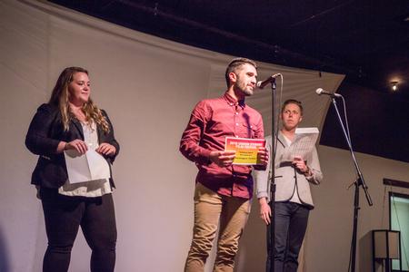 Christian Al-Hagal, sophomore theatre major, steps on the stage to receive best original score award for his film <i>The Garden</i> during the Union Student Film Festival. - Photo by David Parks