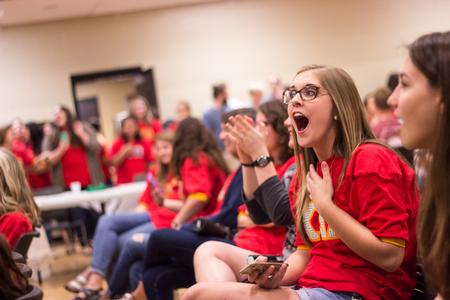 Maggie Whitaker, freshman music major, expresses surprise upon seeing the talent of her sorority sisters on stage.  - Photo by David Parks