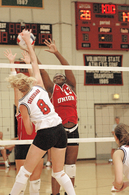 Kenyan native Phylis Anyango, goes up high to block a shot during a game against Cumberland. Union went on to remain undefeated in conference play with a three-game sweep. - Photo by Lindsay Stavish