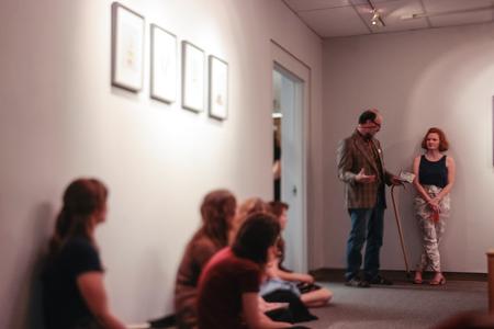 Lee Benson, professor of art and department chair, thanks guests for participating in the art reception, opening the floor to questions for photographer Lily Glass.  - Photo by David Parks