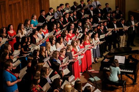 Alumni from the past decade joined the University Singers on stage at the end of the spring choral concert. The group performed an arrangement of Be Thou My Vision as a gift to Chris Mathews, who will be transitioning to another university after the semester ends. - Photo by Kristi McMurry Woody
