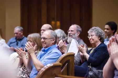 Band members' families and friends support them between pieces during the symphonic band concert in First Baptist Church.  - Photo by David Parks