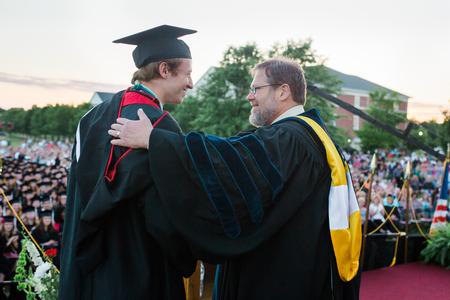 Nathaniel Magnuson, English with honors graduate, receives the Tigrett medal from C. Ben Mitchell, provost, during spring commencement services.  - Photo by Kristi McMurry Woody