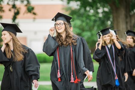 Olivia Winters, English graduate, processes with her classmates to the Great Lawn for spring commencement services. - Photo by Kristi McMurry Woody