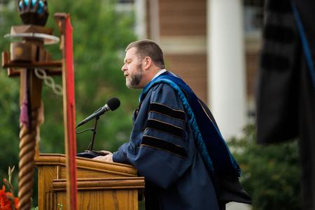 J. Michael Thigpen, executive director of The Evangelical Theological Society, gives the invocation at spring commencement services.  - Photo by Kristi McMurry Woody