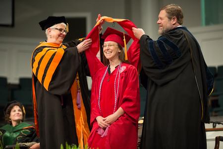 Andrea Baker, doctor of nursing practice graduate, receives her doctoral hood during Summer Commencement. - Photo by Kristi McMurry Woody