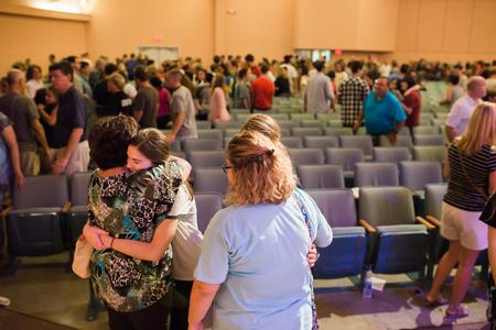 New students hug their parents and siblings at the conclusion of chapel during Welcome Week. - Photo by Kristi McMurry Woody