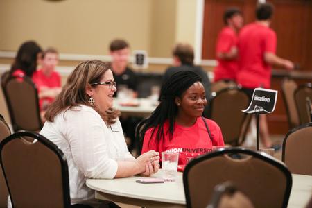 Nancy Cherry, professor of education, talks with new students about their interest in becoming educators during the Dinner with Your Department event. - Photo by Kristi McMurry Woody