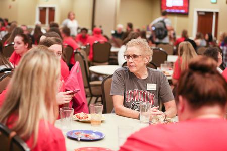 Carol Whaley, professor of education, chats with students during the Dinner with Your Department event that is an annual part of Welcome Week.  - Photo by Kristi McMurry Woody