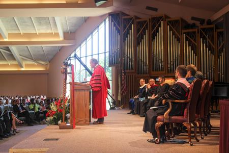 Dub Oliver, president of the university, delivers the message at Convocation. - Photo by Morgan Morfe