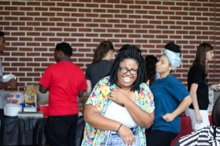 Michaya Reeves, senior psychology major, enjoys a good laugh at the MOSAIC cookout to kick off the semester.  - Photo by Morgan Morfe