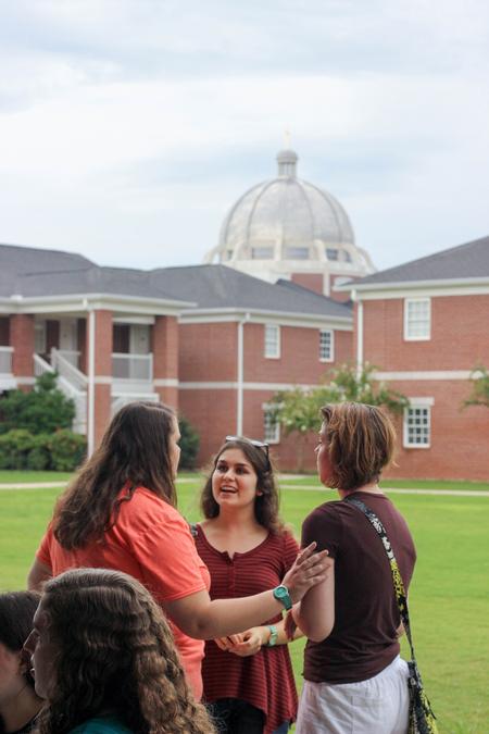Jessica Barton, junior intercultural studies major, Talia Friesen, junior visual arts major, and Abigail Kerr, junior French major, chat at the MOSAIC Cookout on the Bowld Commons back patio.  - Photo by Morgan Morfe