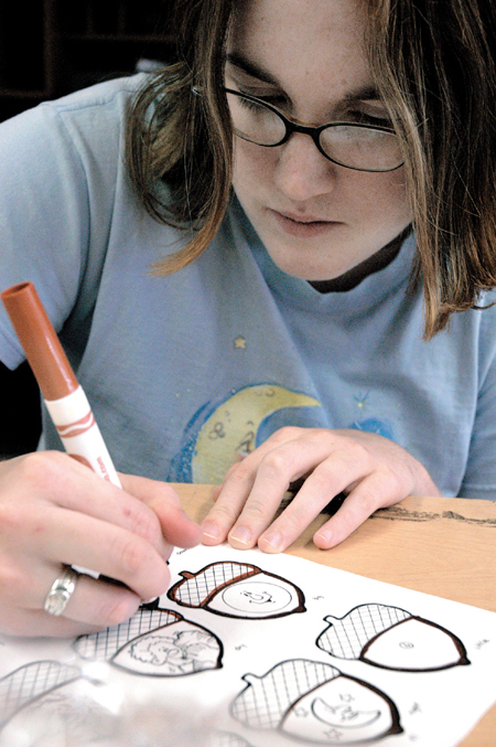 Sophomore, Heather Fleming recreates games lost during the tornado that hit Denmark Elementary. The second annual Day of Remembrance was a time to serve in Jackson. - Photo by Kathleen Murray