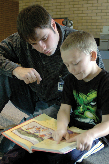 Senior Clint Smith spent time with children at Nova Elementary during Day of Remembrance. - Photo by Lindsay Stavish