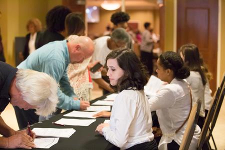 Breanne Vailes, programming coordinator for the Vocatio Center, checks guests in for the Remember Me Walk. - Photo by Kristi McMurry Woody