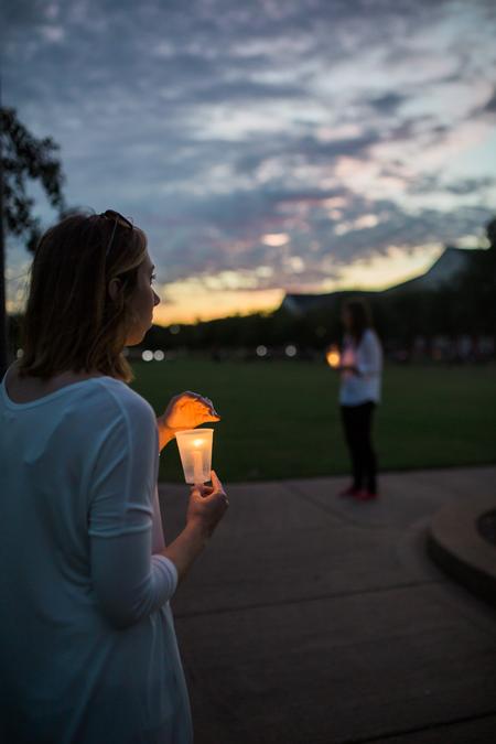 Social work students hold candles to light the Remember Me Commemorative Walk for homicide-loss survivors. - Photo by Kristi McMurry Woody