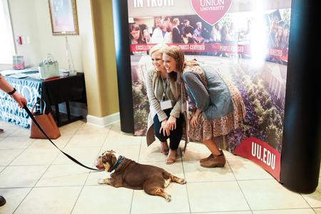 Guests of Day at the U pose with Buster during check-in. - Photo by Kristi McMurry Woody