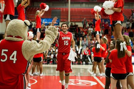 Senior bulldog, Felipe Rocha, gets ready to give throwback-Buster a high-five during Bulldog Madness.  - Photo by Morgan Morfe