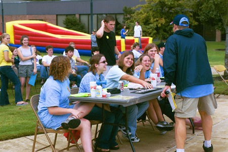 Mark VanderHaar confers with the judges about the Battle of the Bands at Fall Fest 2002. - Photo by Kristen Hiller