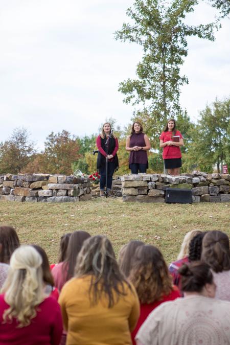 Stephanie Olford, senior psychology major, Hillarie Henderson, Union University alumna, and Katie Green, senior nursing major, lead a song in honor of Leighton Williams, a Chi Omega sister who passed away in September 2013.  - Photo by Morgan Morfe