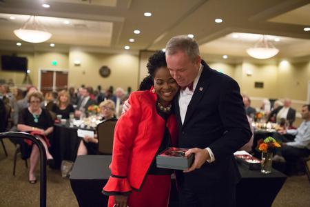 Reneé Jones ('03), director of the Hundley Center for Academic Enrichment, receives the G.M. Savage Legacy Award from Dub Oliver, president of the university, during the Meritorious Service Awards Banquet. - Photo by Kristi McMurry Woody