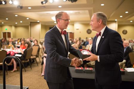 Robert Briley ('85) receives a Distinguished Achievement Award in Education from Dub Oliver, president of the university, during the Meritorious Service Awards Banquet over homecoming weekend.  - Photo by Kristi McMurry Woody